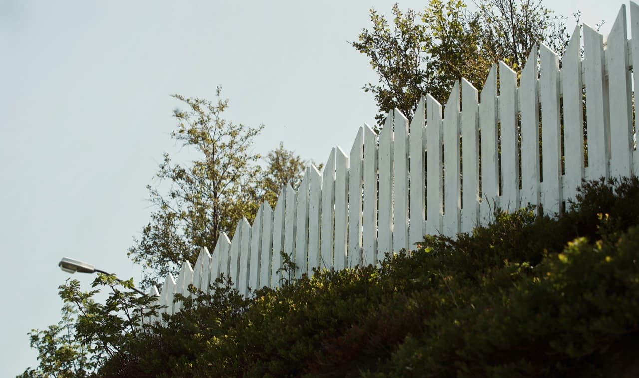 White vinyl fence install along a residential property line in Union County, NJ